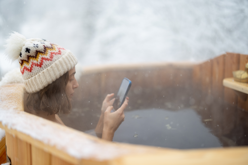 A woman looking for information on how to use a wood-fired hot tub.